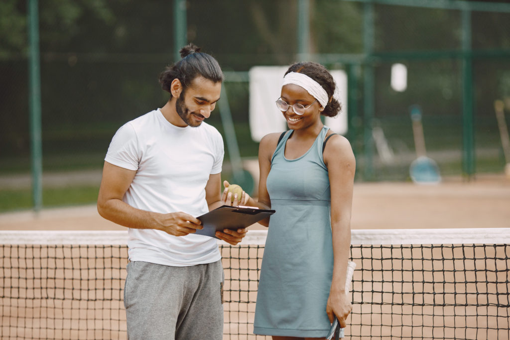 Two tennis players reading a rules before the match